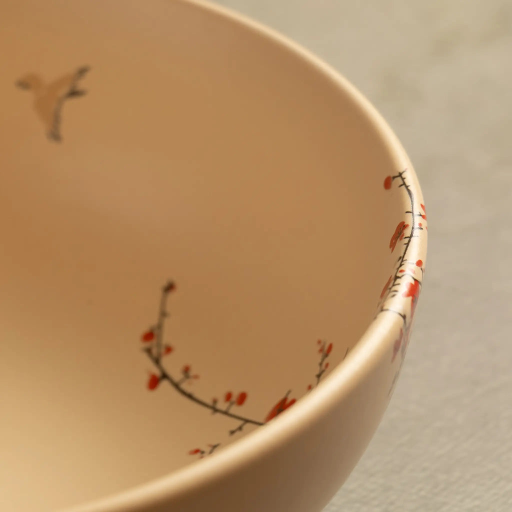 Close-up of Sakura salad bowl rim with blossom and bird detail