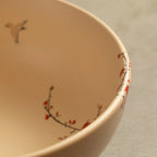 Close-up of Sakura salad bowl rim with blossom and bird detail