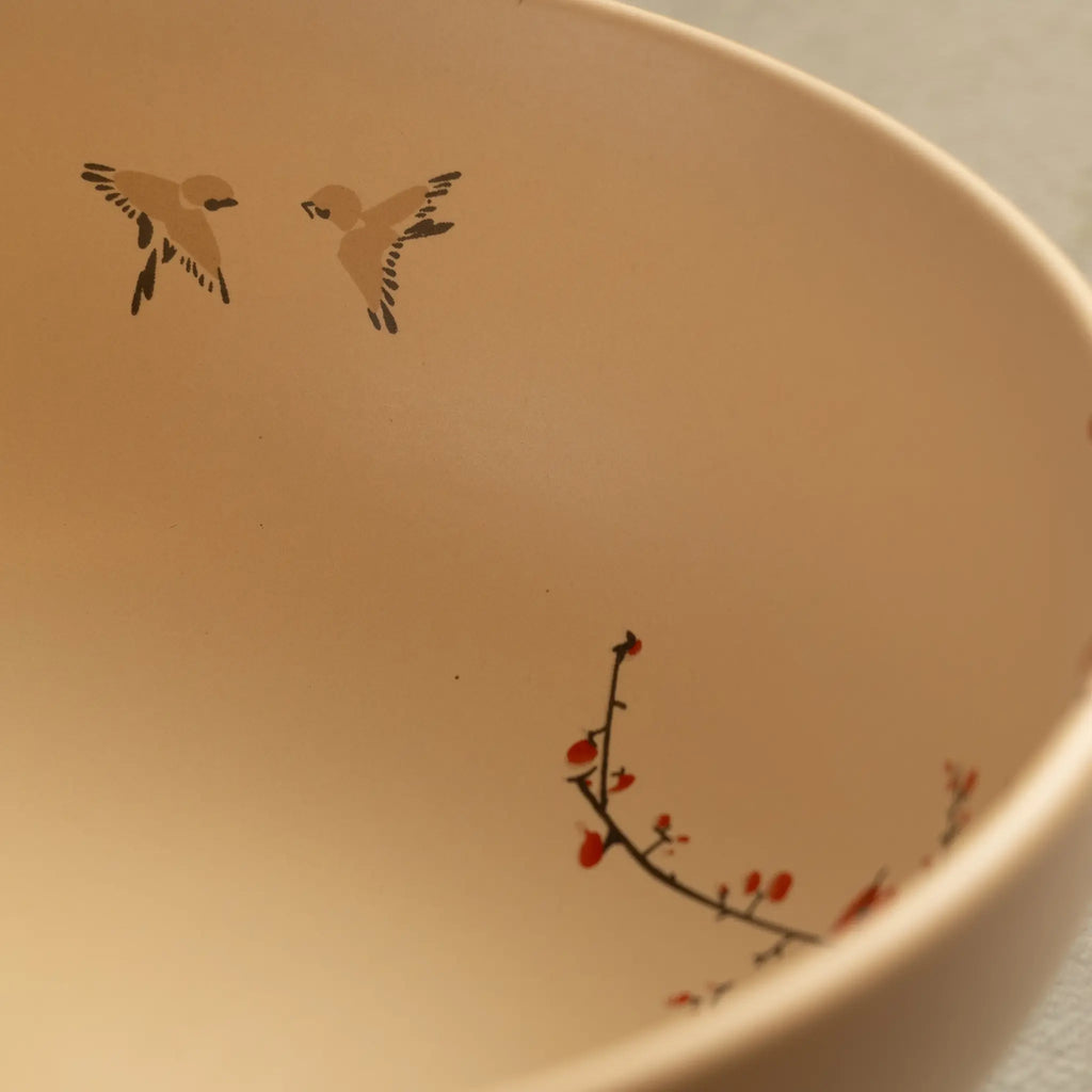 Sakura salad bowl close-up with painted birds and blossom branch