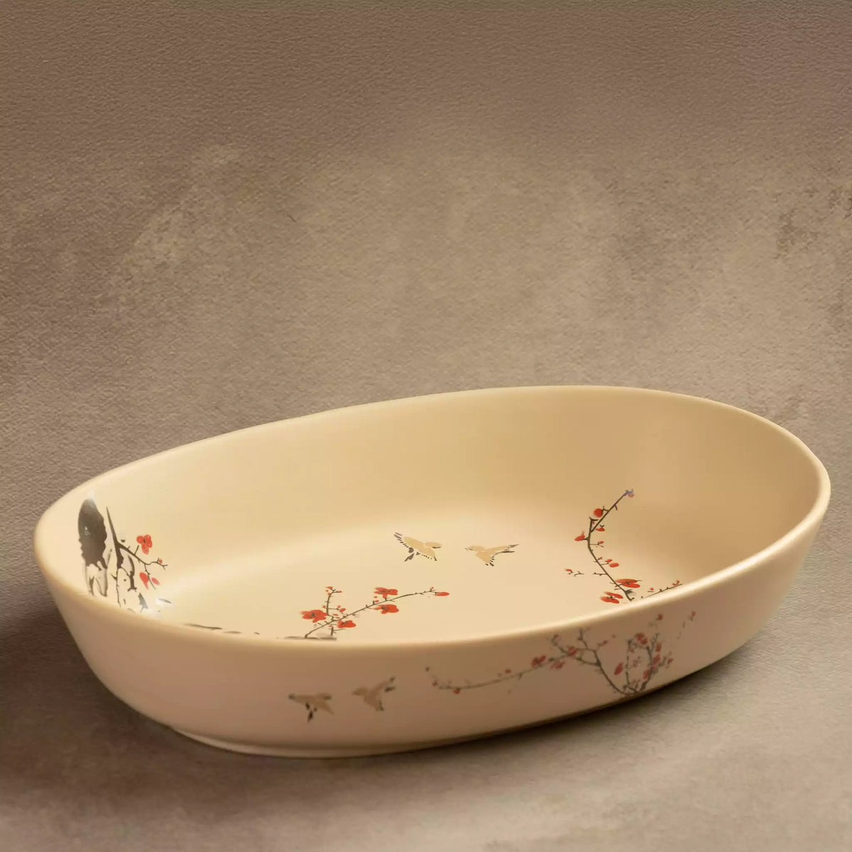 Sakura oval ceramic baking dish with hand-painted blossom border