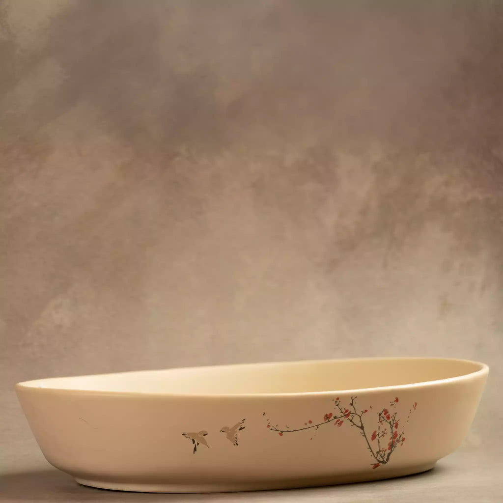Sakura oval baking dish side view in beige stoneware