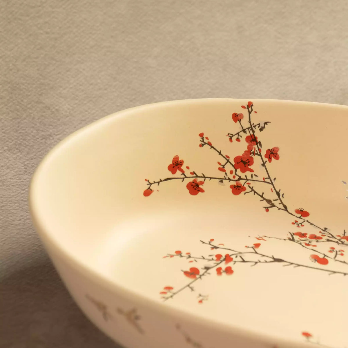 Sakura oval baking dish close-up with blossom branch detail