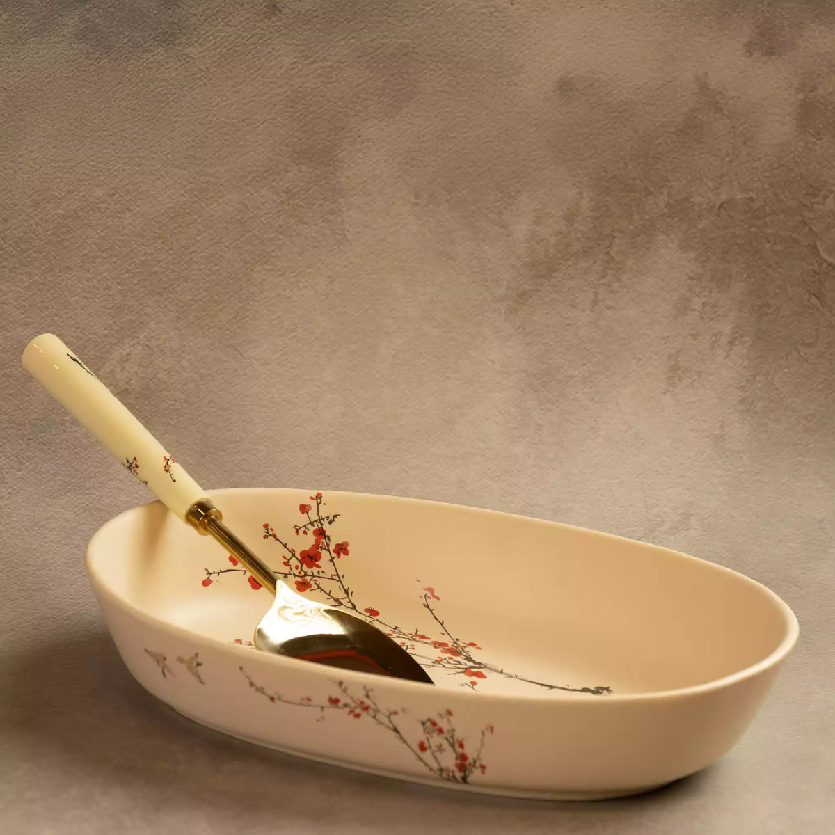 Sakura baking dish with brass serving spoon inside