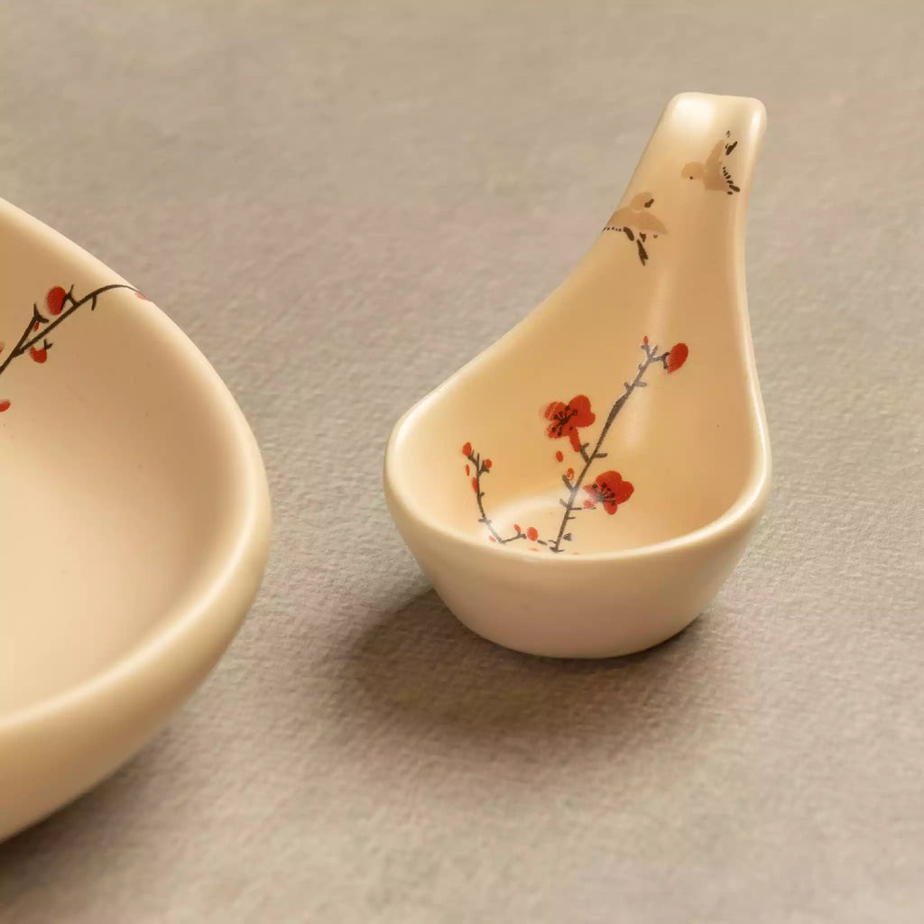 Sakura ceramic ladle spoon upright beside oval platter