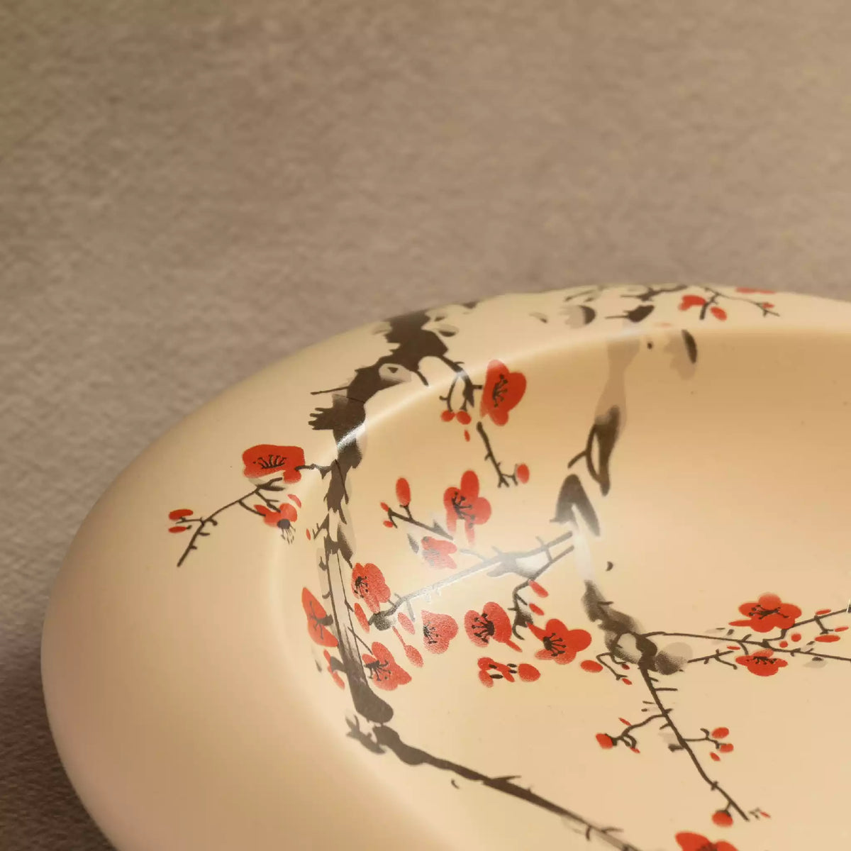 Close-up of Sakura oval platter with blossom branch and bird painting