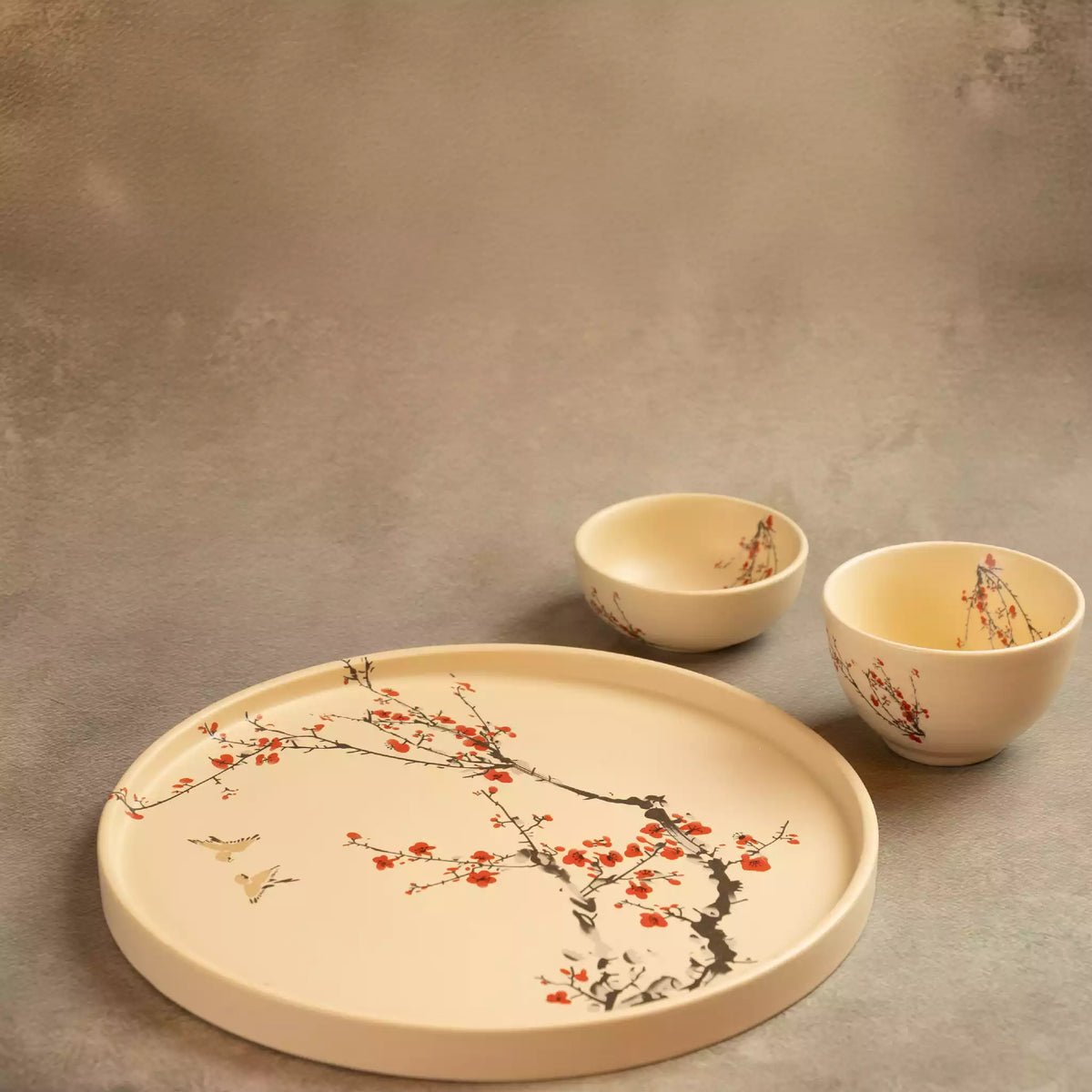 Sakura dinner plate with bowls on grey backdrop, blossom design