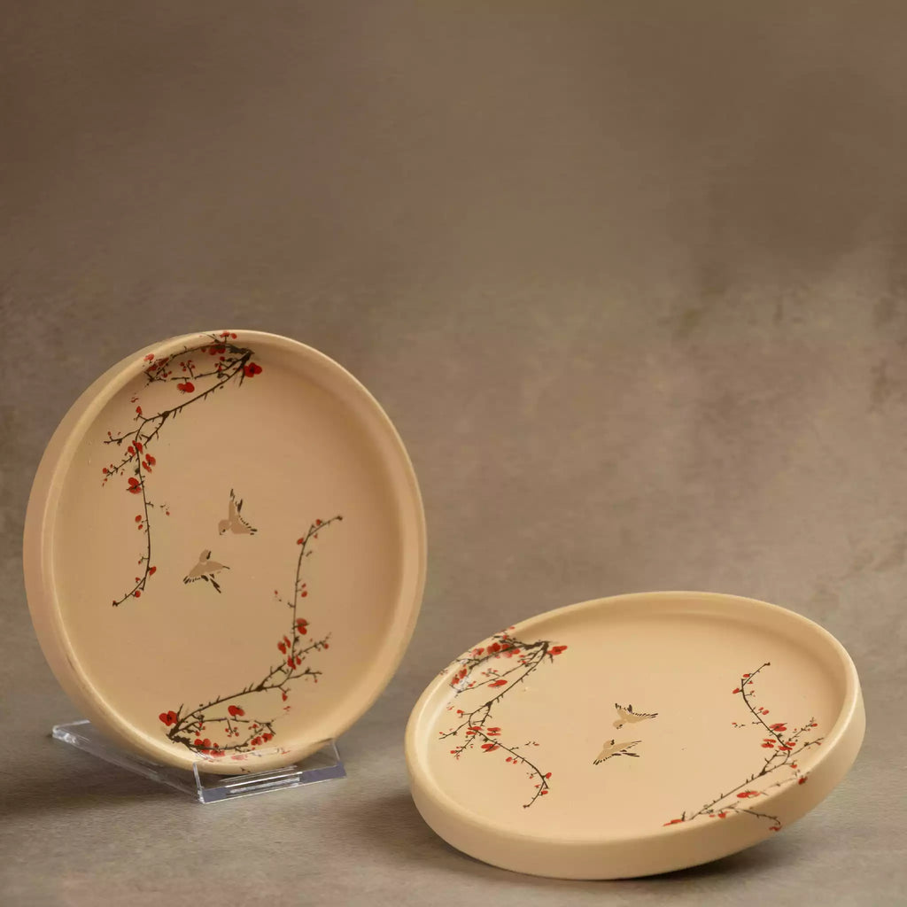 Sakura side plate upright beside flat plate on grey backdrop