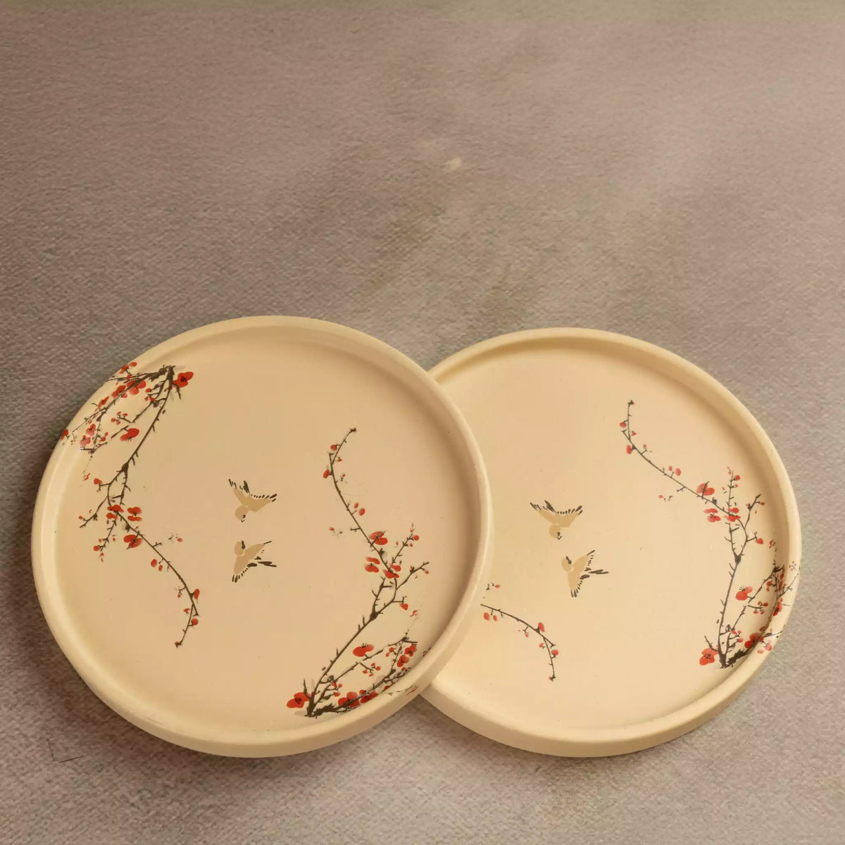 Sakura side plates pair, beige ceramic with red blossom detail