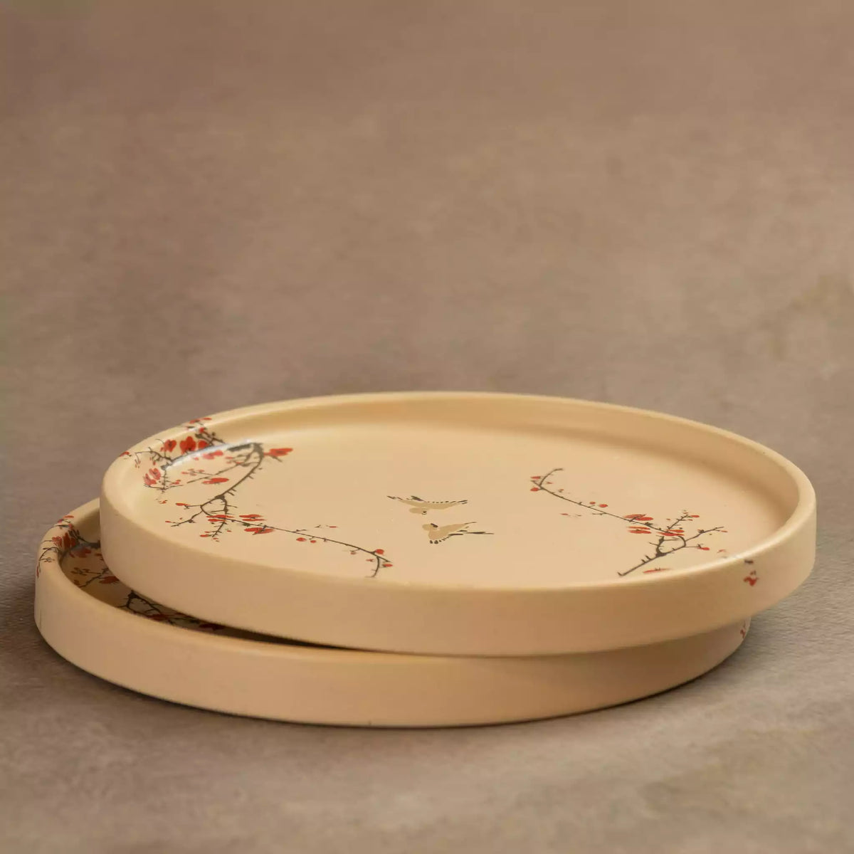 Stacked Sakura side plates showing rimmed edge and blossom motif