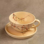 Sakura tea cup on saucer with hand-painted cherry blossom branch