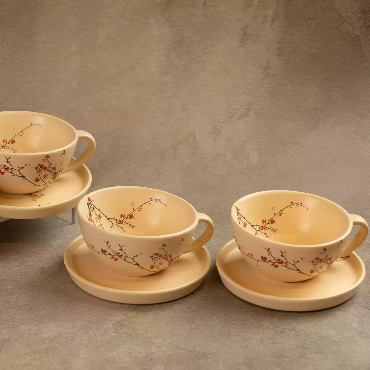 Three Sakura tea cups on saucers with hand-painted cherry blossoms