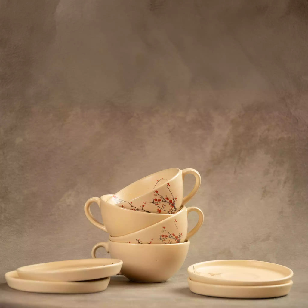 Stacked Sakura tea cups and saucers in beige cherry blossom ceramic