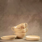 Stacked Sakura tea cups and saucers in beige cherry blossom ceramic