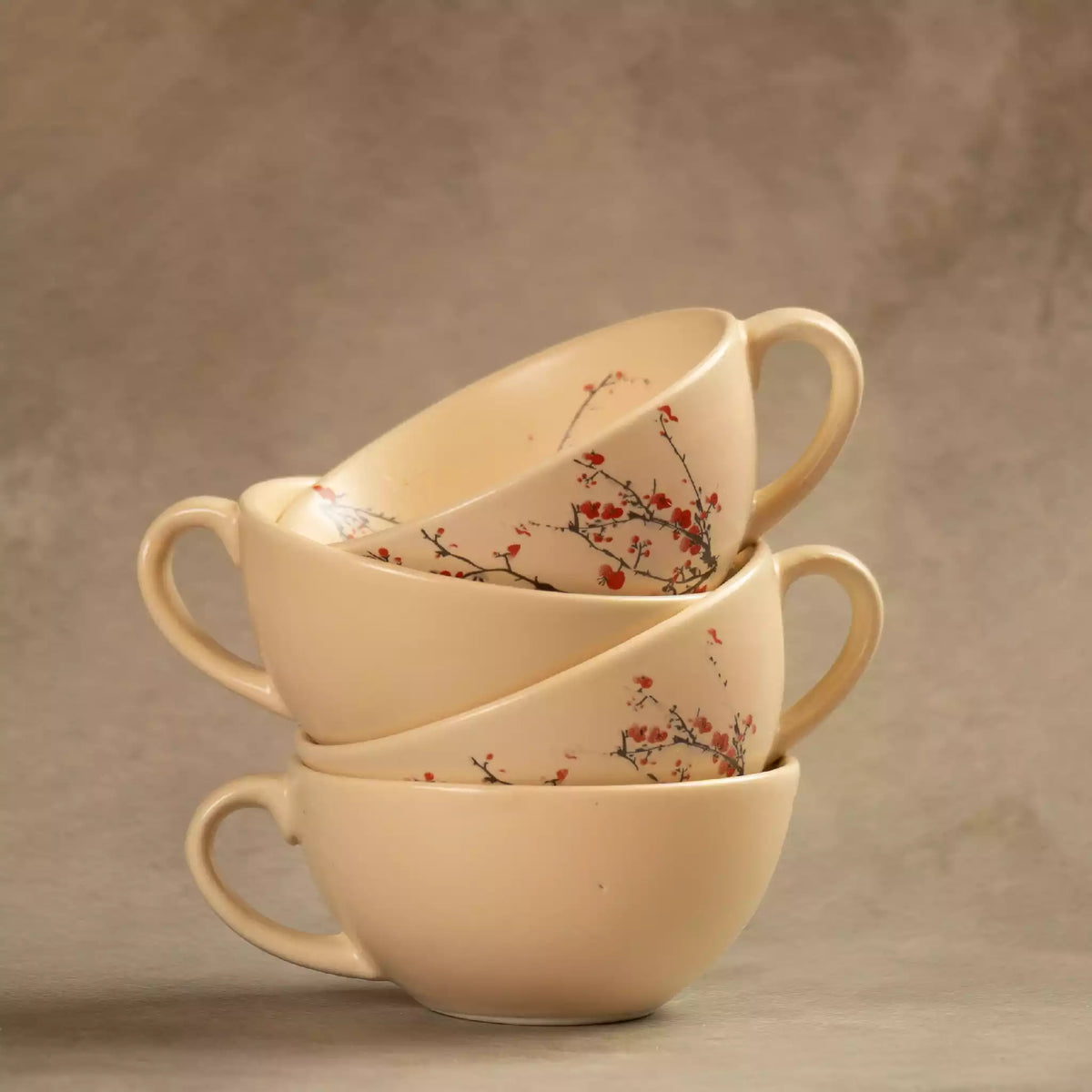 Two stacked Sakura ceramic tea cups with cherry blossom pattern