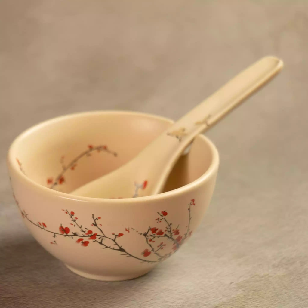 Sakura soup bowl with ceramic spoon resting inside, cherry blossom design