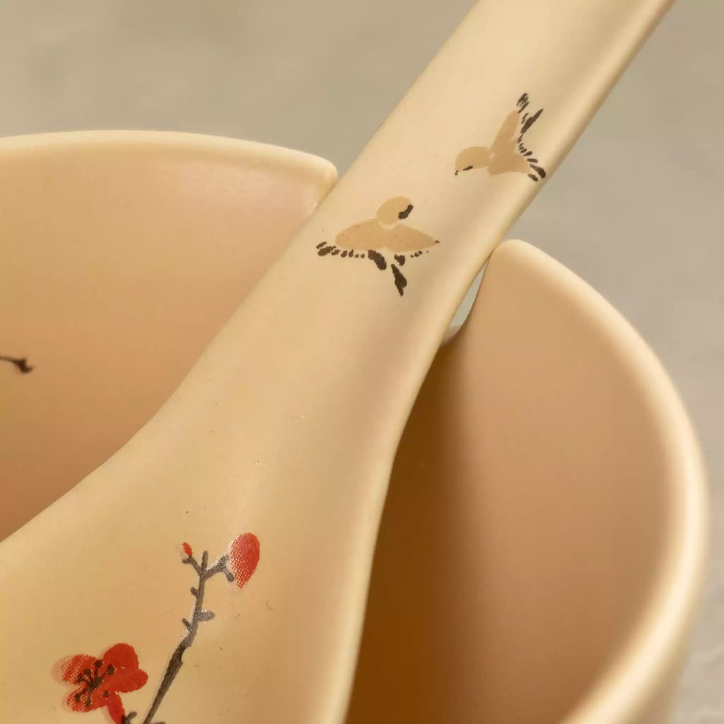 Close-up of Sakura ceramic soup spoon with red cherry blossom detail