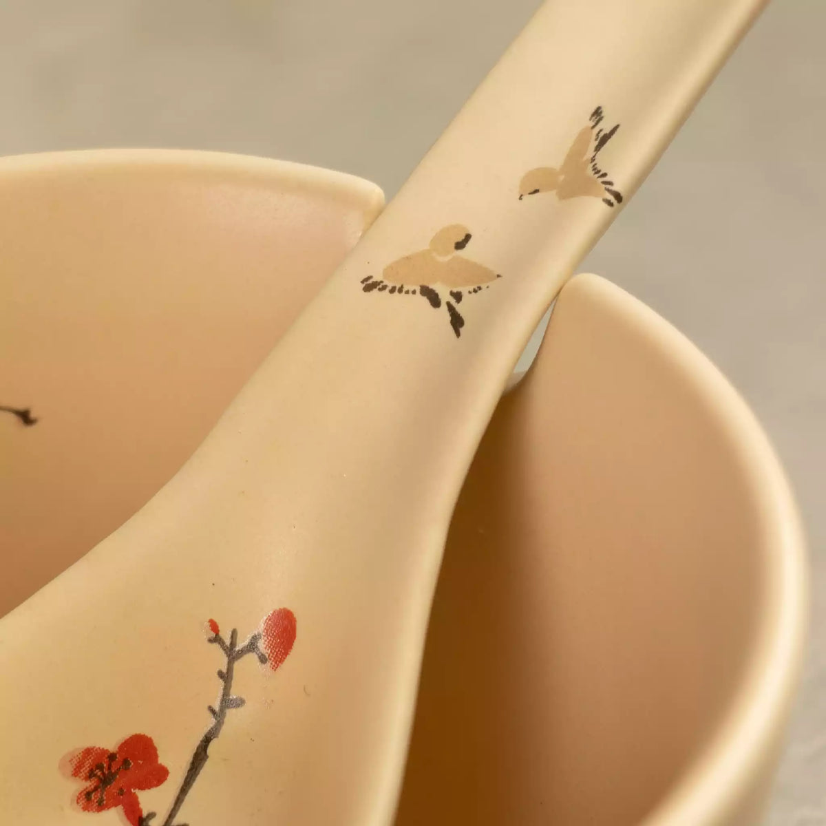 Close-up of Sakura ceramic soup spoon with red cherry blossom detail