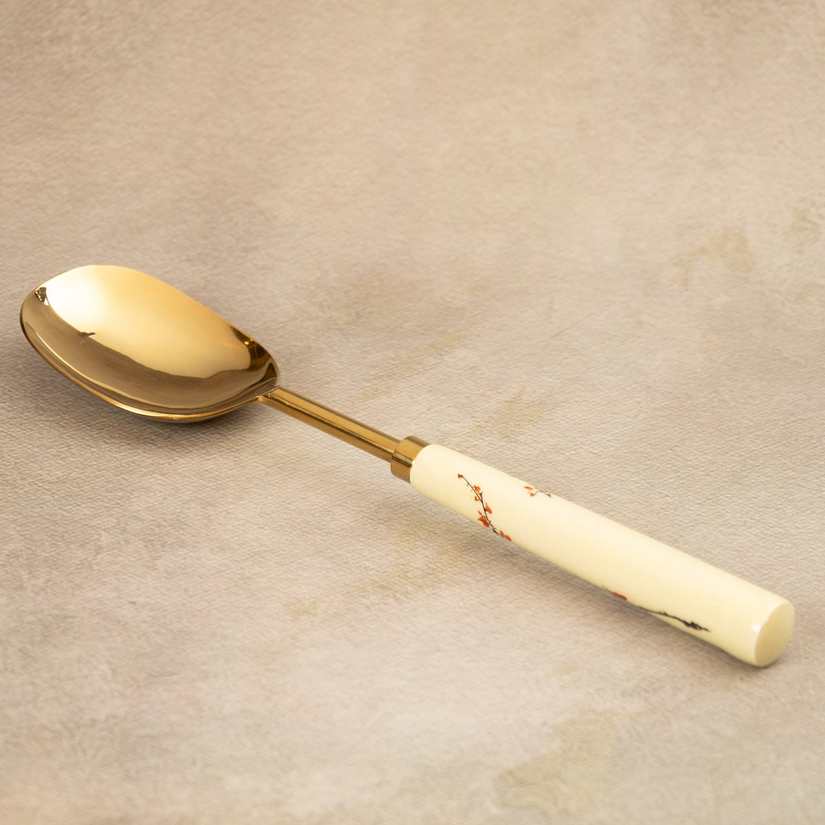 Sakura brass serving spoon with white blossom-painted handle