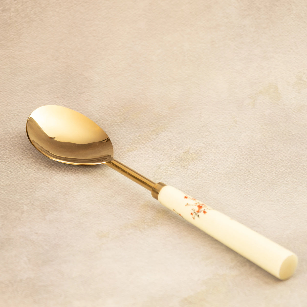 Sakura serving spoon angled view with painted blossom handle