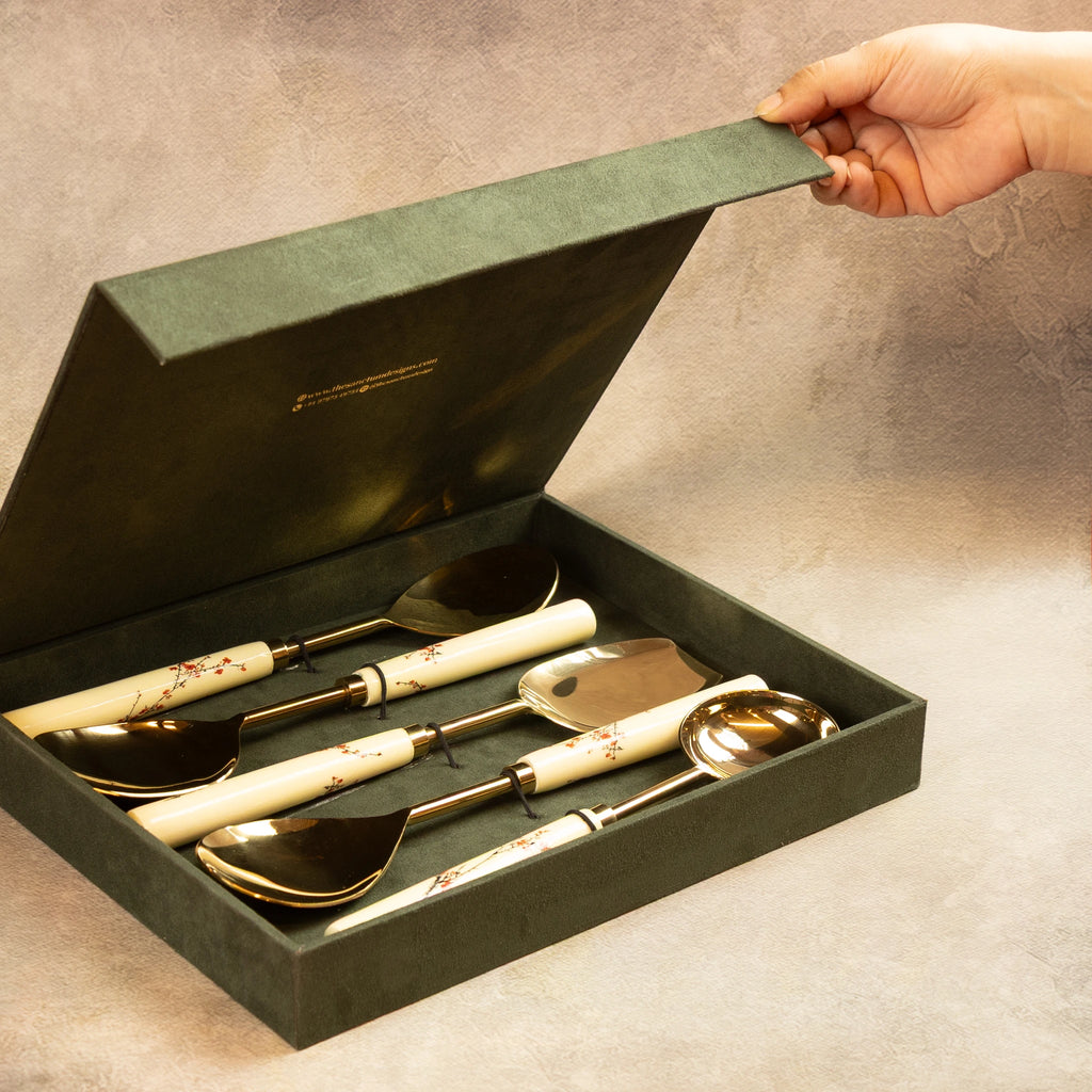 Hand opening green gift box of Sakura serving spoons set