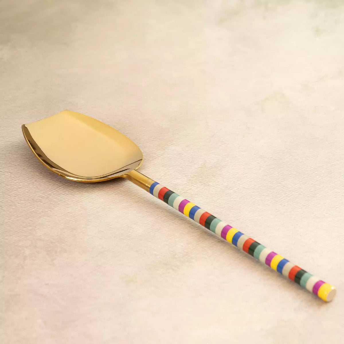 Rainbow brass flat server with multicolour beaded handle