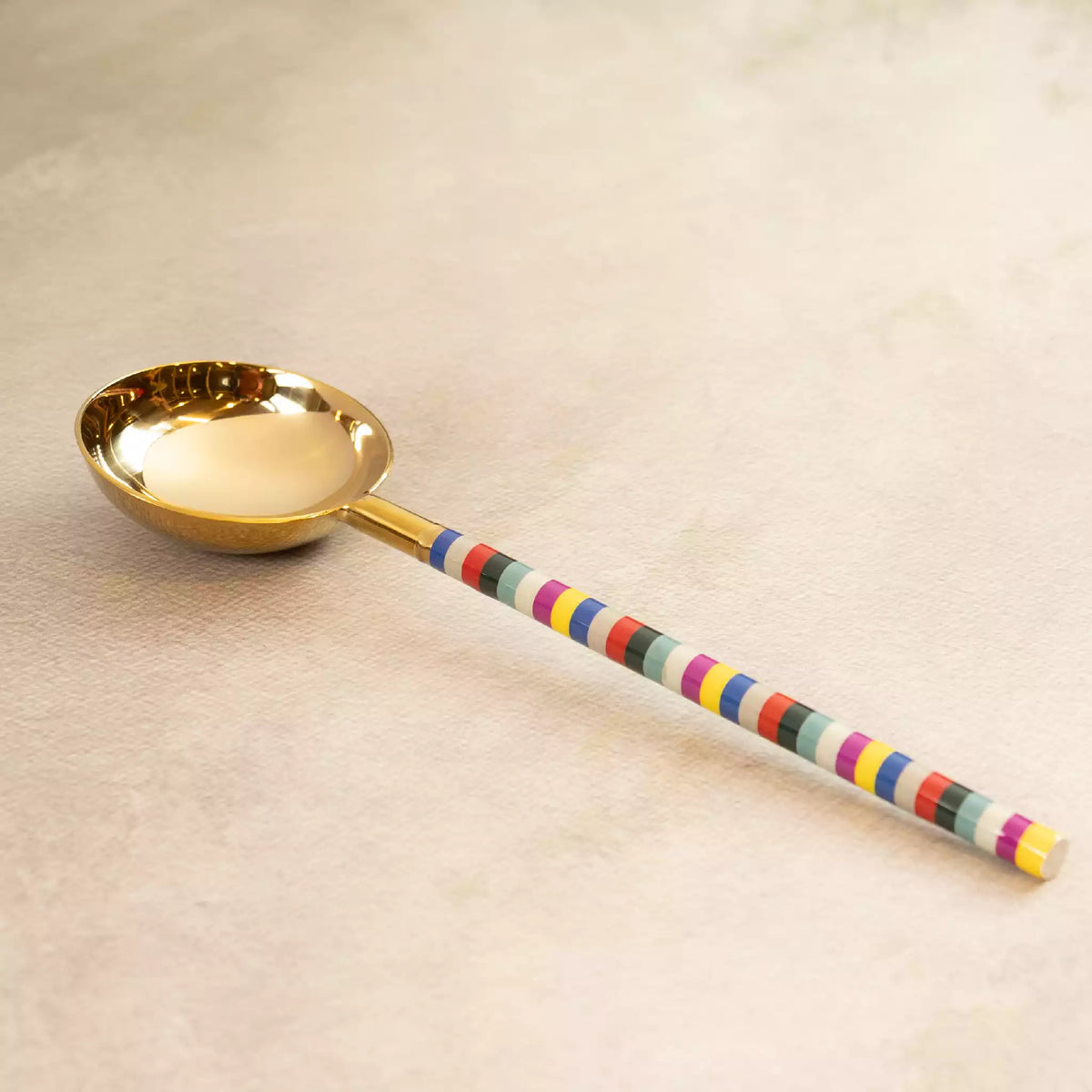 Rainbow gold ladle with colourful striped handle