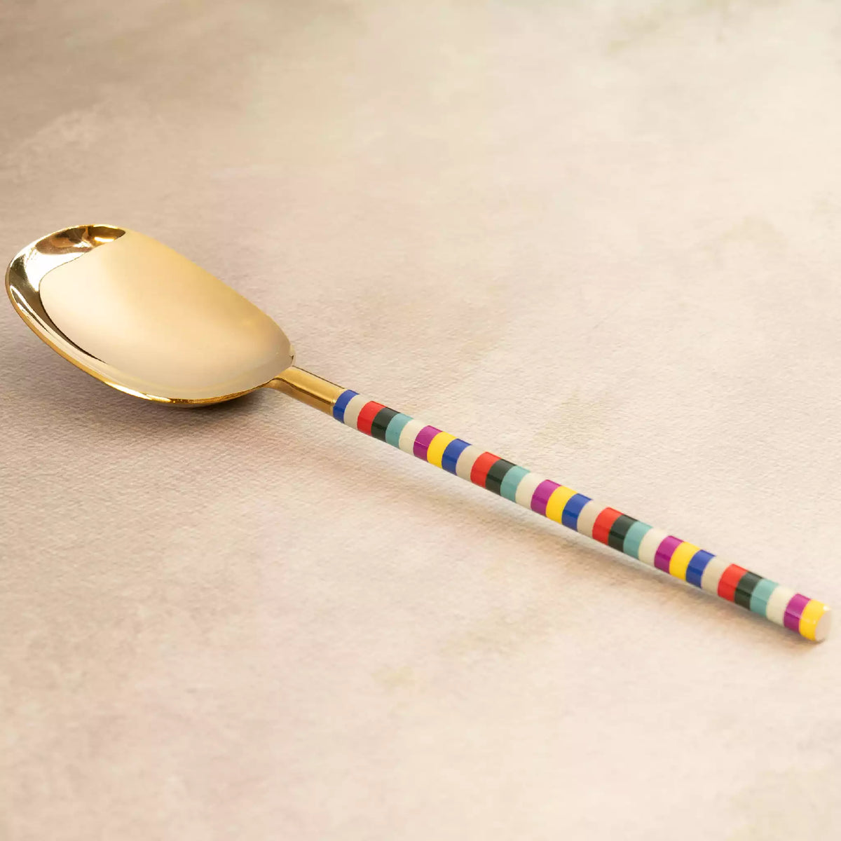 Rainbow gold serving spoon with colourful striped handle