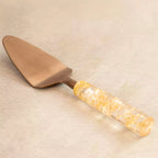 Gold dust brass spatula with gold-flecked resin handle