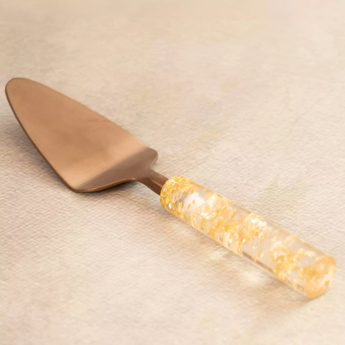 Gold dust brass spatula with gold-flecked resin handle