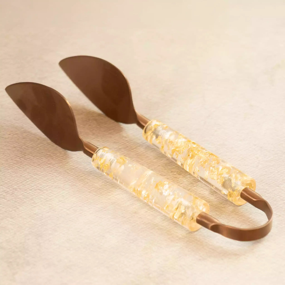 Gold dust serving tongs pair with speckled acrylic handles