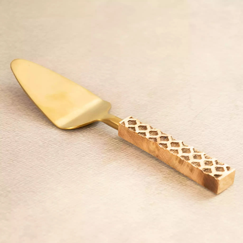 Brass cake server with perforated carved handle