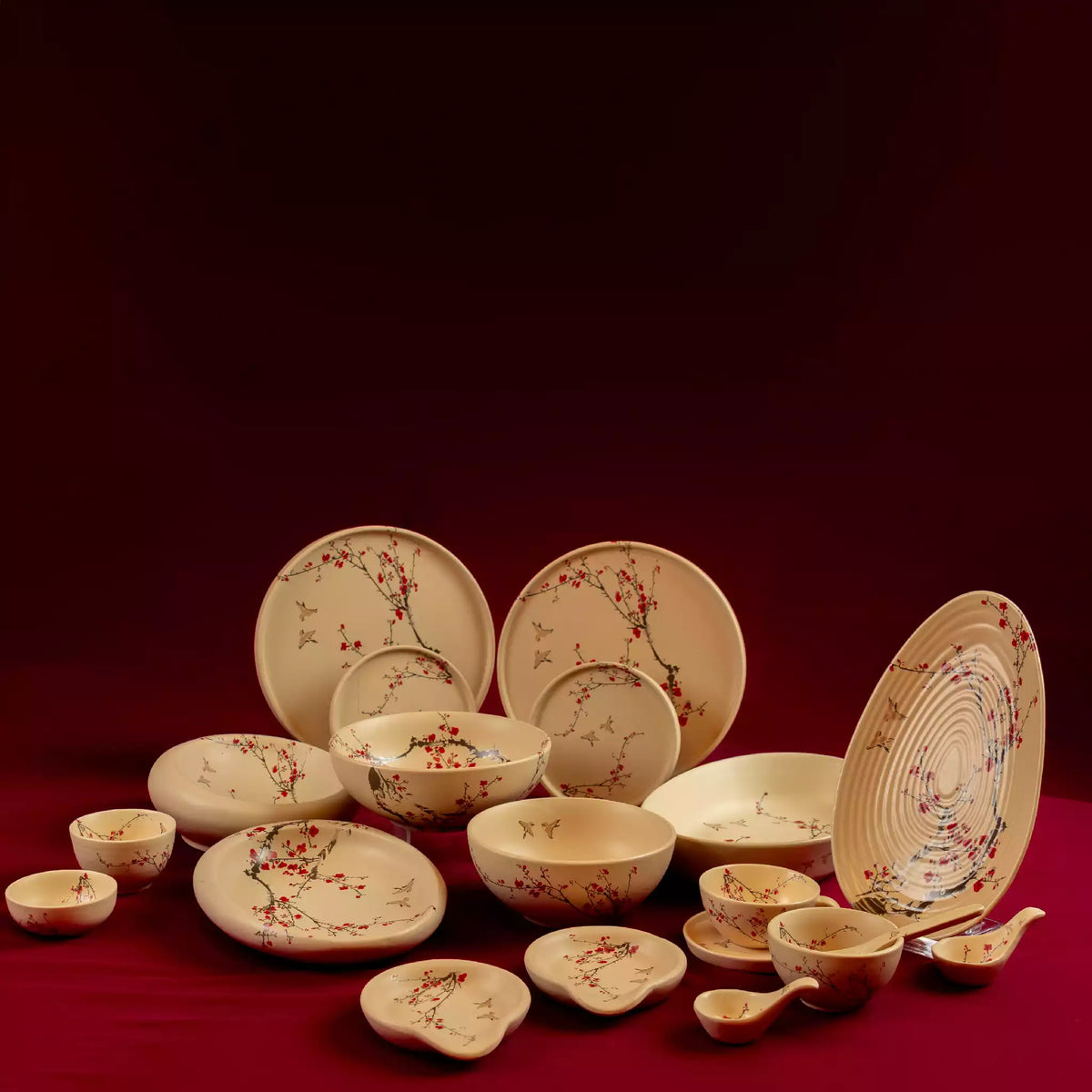 Complete Sakura dinner set of 6 styled on deep red backdrop, cherry blossom ceramics