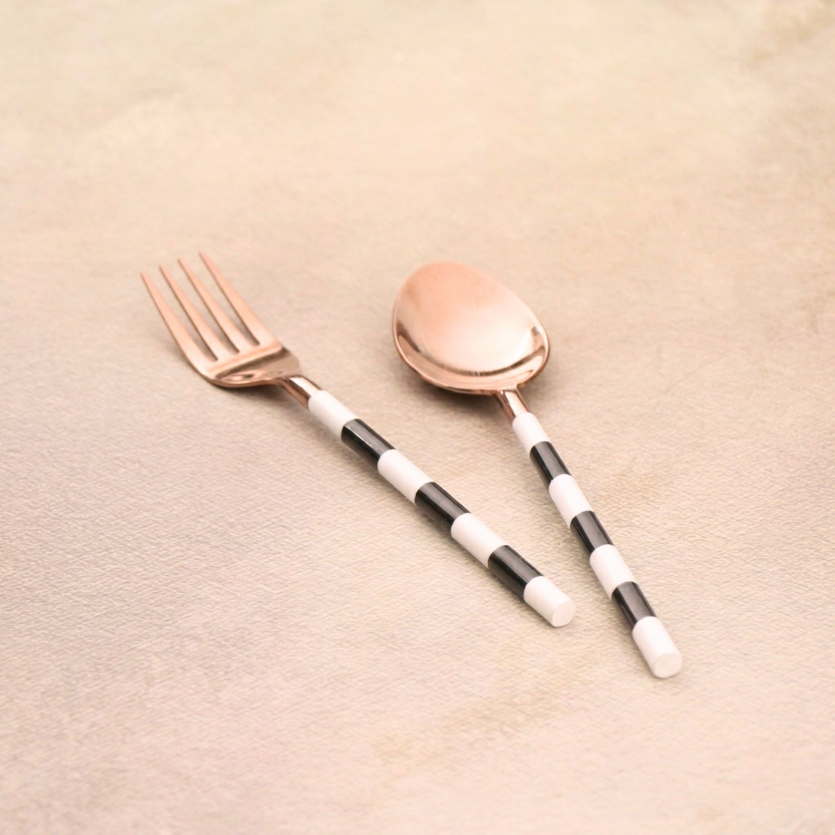 Rose gold fork and spoon pair with striped handles