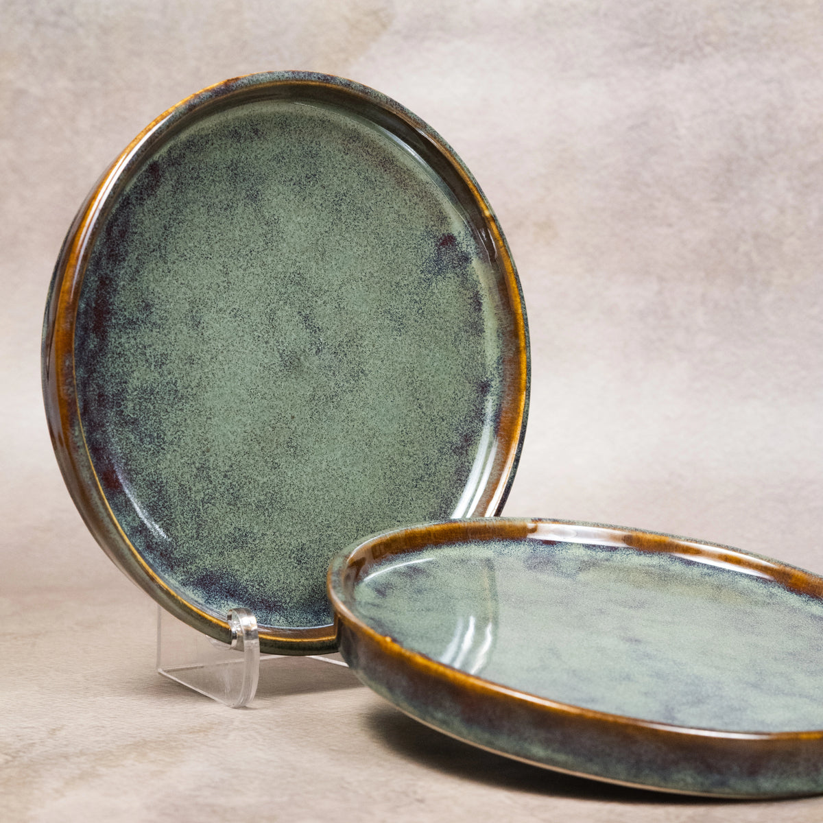 Sage green round cocktail plates with reactive glaze