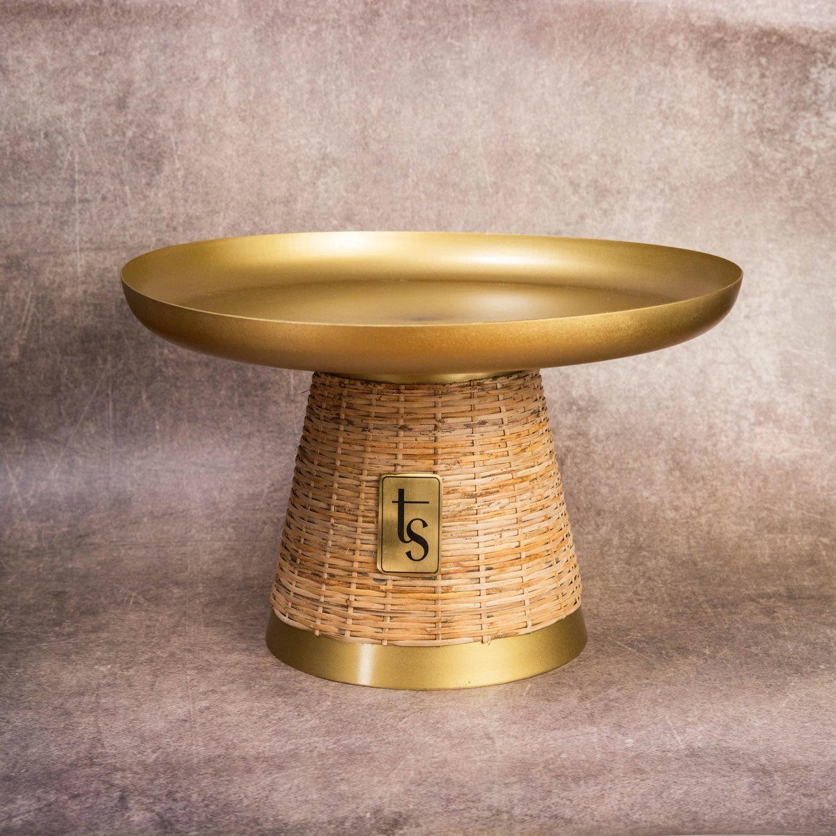 Wicker and metal cake stand with gold top and cane base
