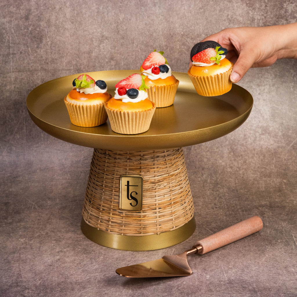 Hand styling cupcakes on wicker gold cake stand