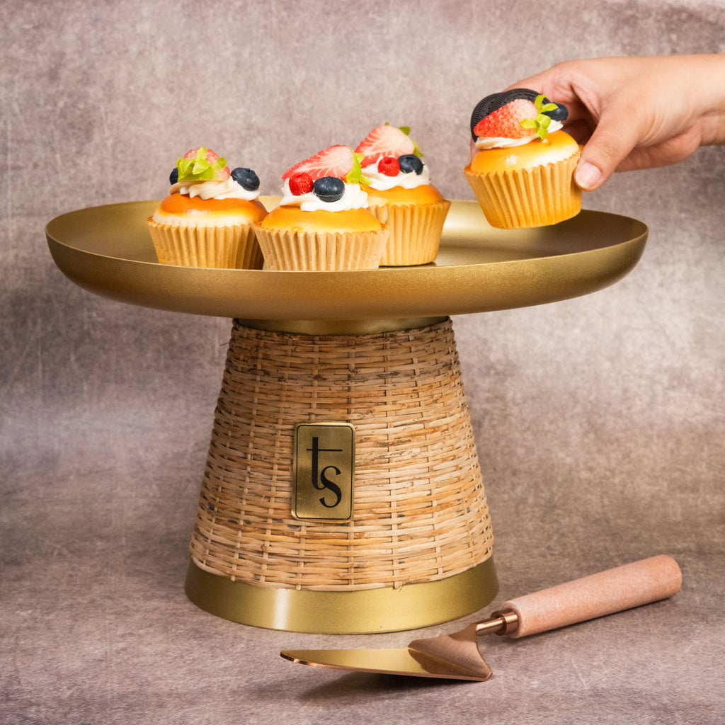 Wicker and metal cake stand with cupcakes and server