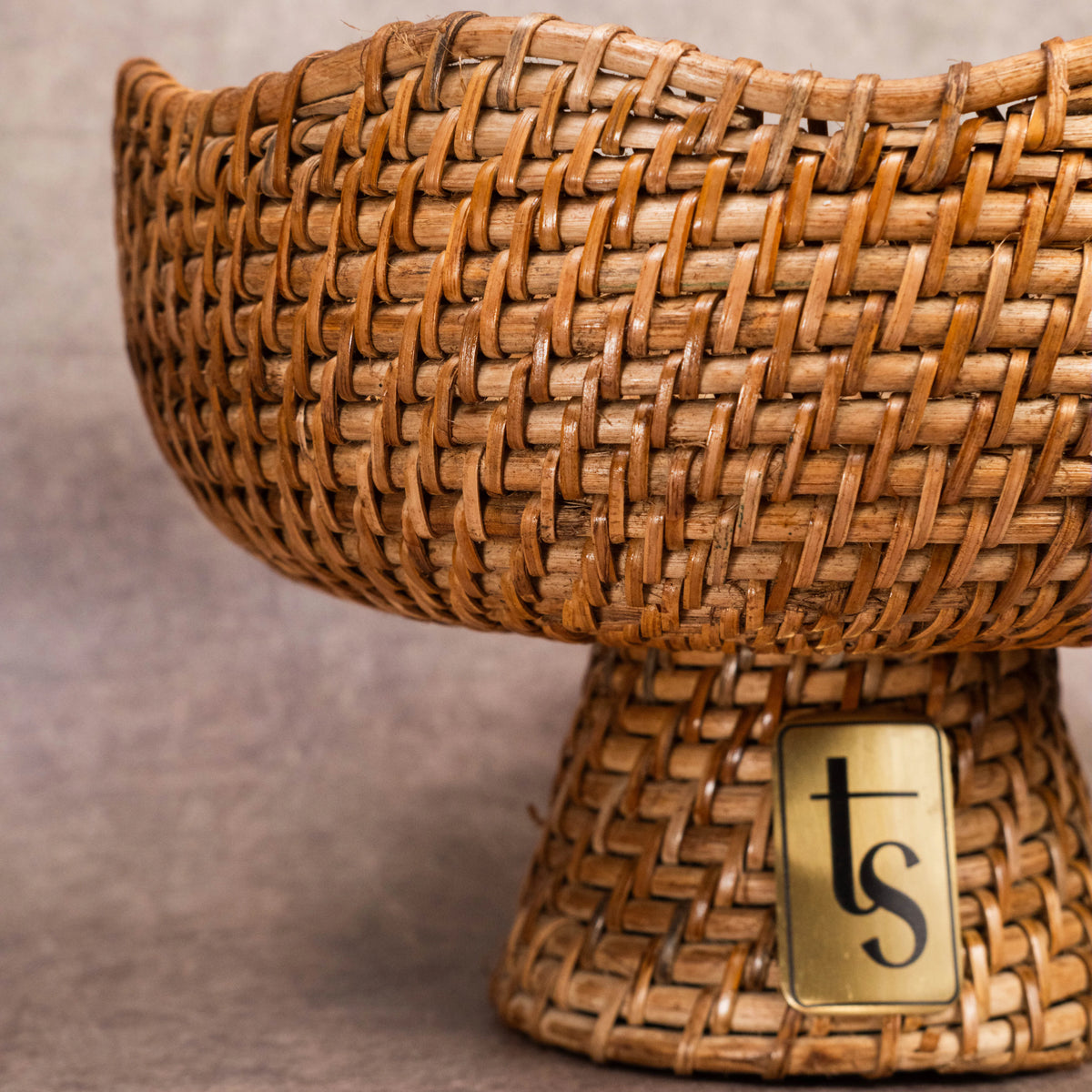 Cane fruit bowl woven texture close-up with logo