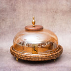 Rattan glass dome with wooden knob on serving tray