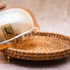 Rattan and glass dome opened beside woven tray