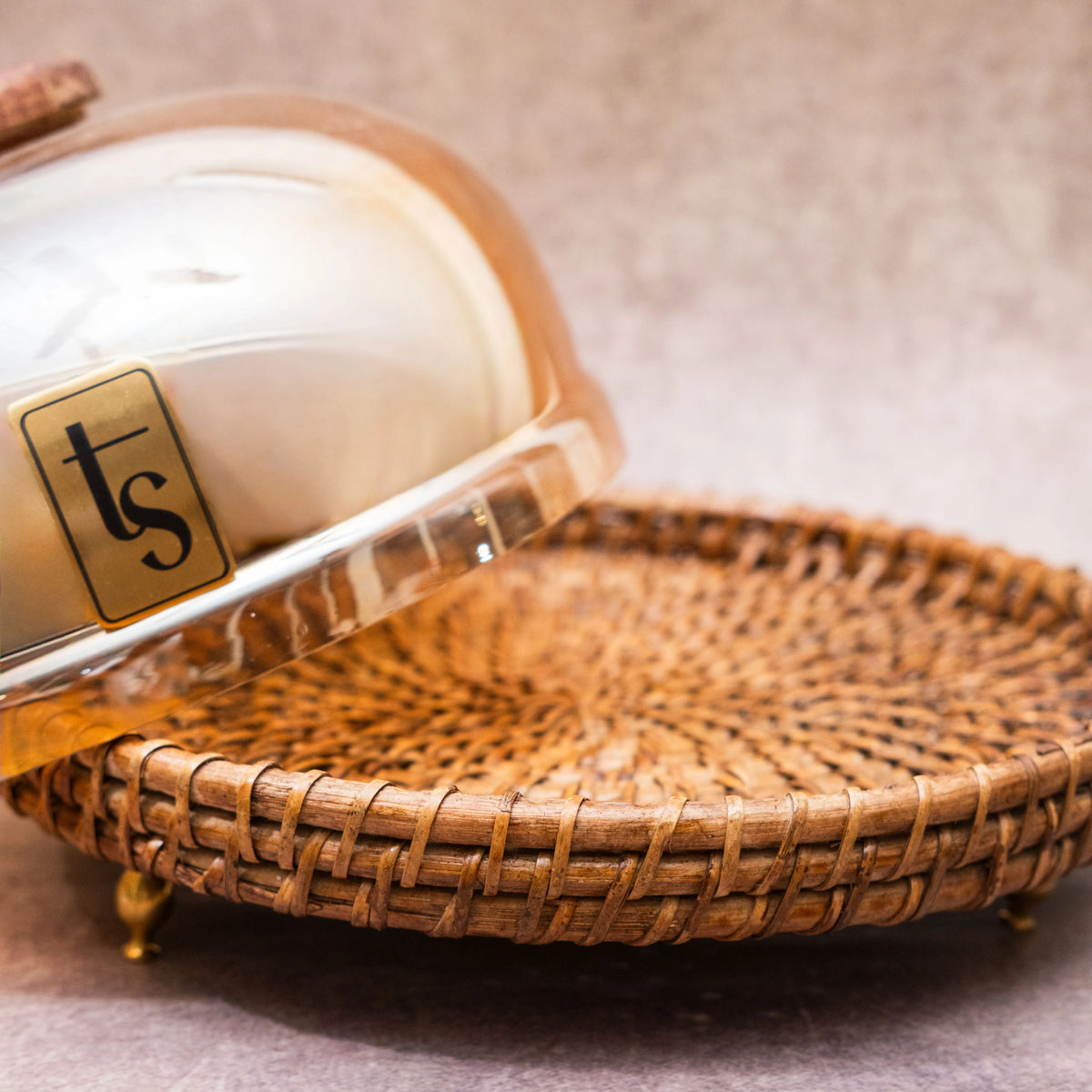 Rattan and glass dome opened beside woven tray