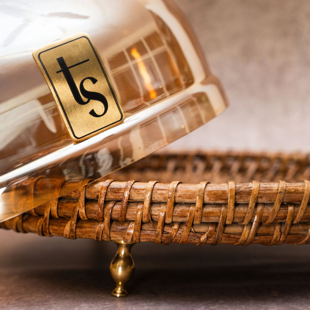 Rattan and glass dome with brand logo on woven tray
