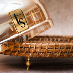 Rattan and glass dome with brand logo on woven tray